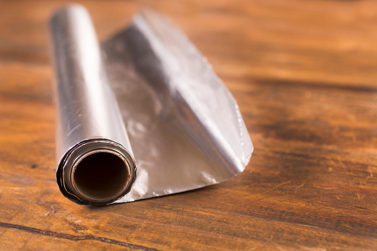 Aluminum foil on a wooden table. 
