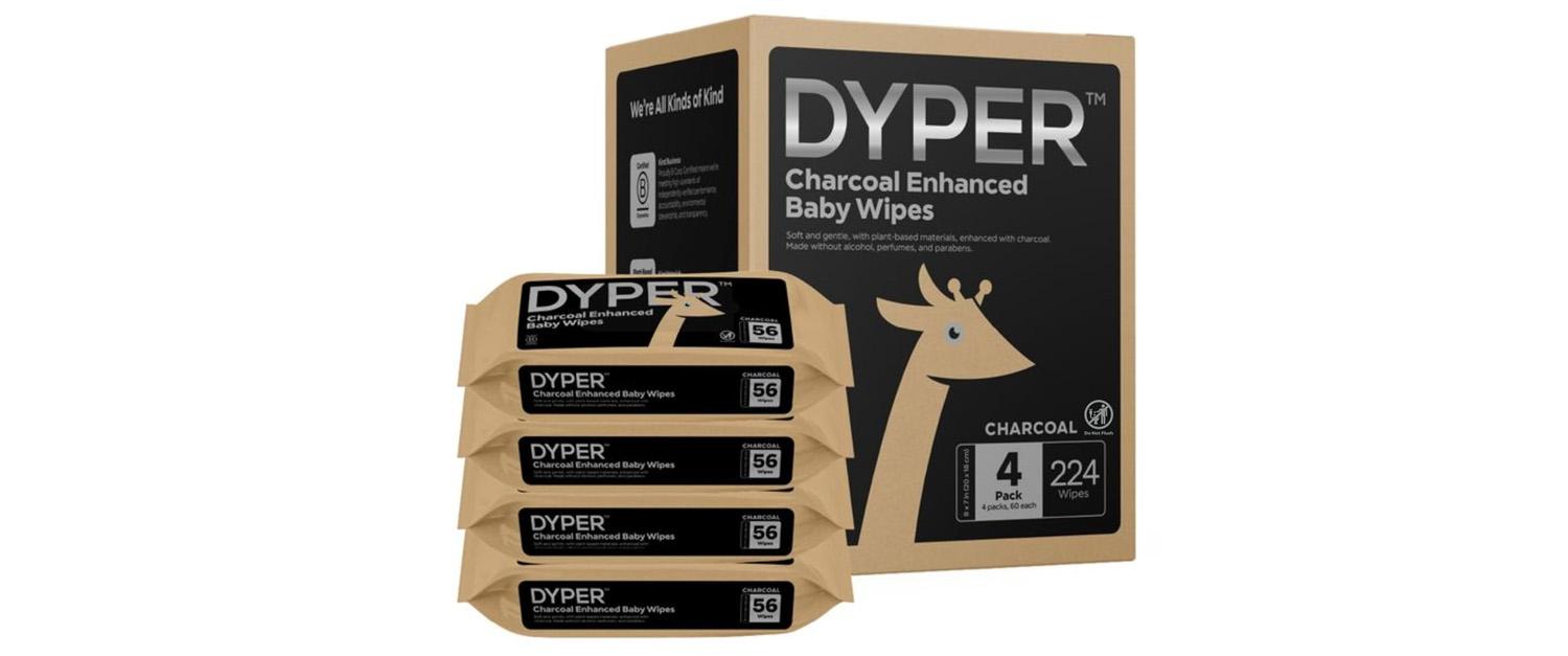 Four packs of baby wipes with black wrappers next to their box