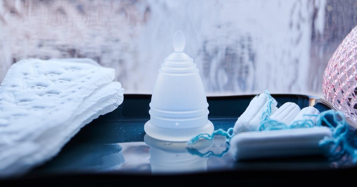 A menstrual cup, panty liners and tampons from different manufacturers are all in one bathroom.
