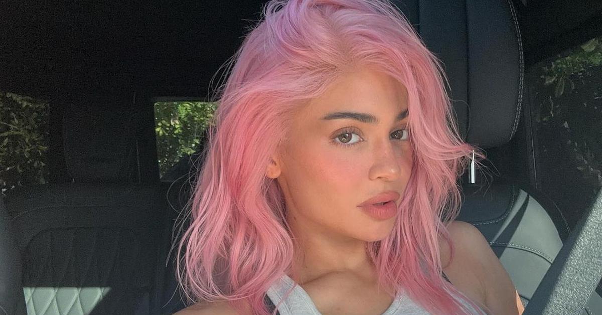 Selfie of Kylie Jenner sitting inside a car with pink hair 