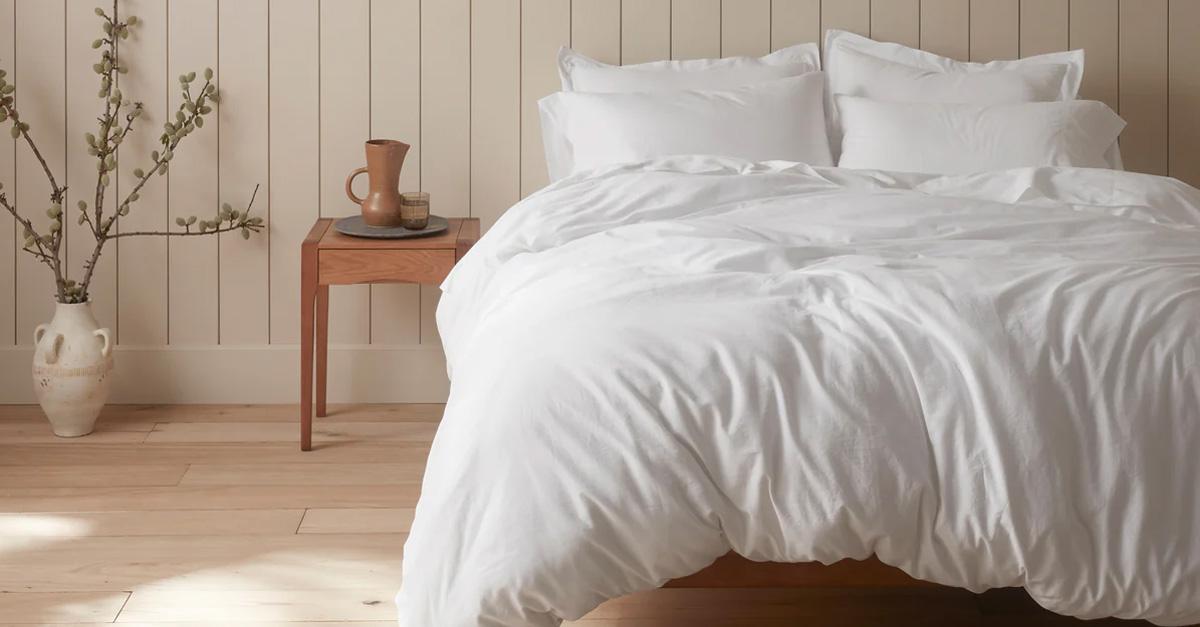 Bed with white sheets in a well-lit room