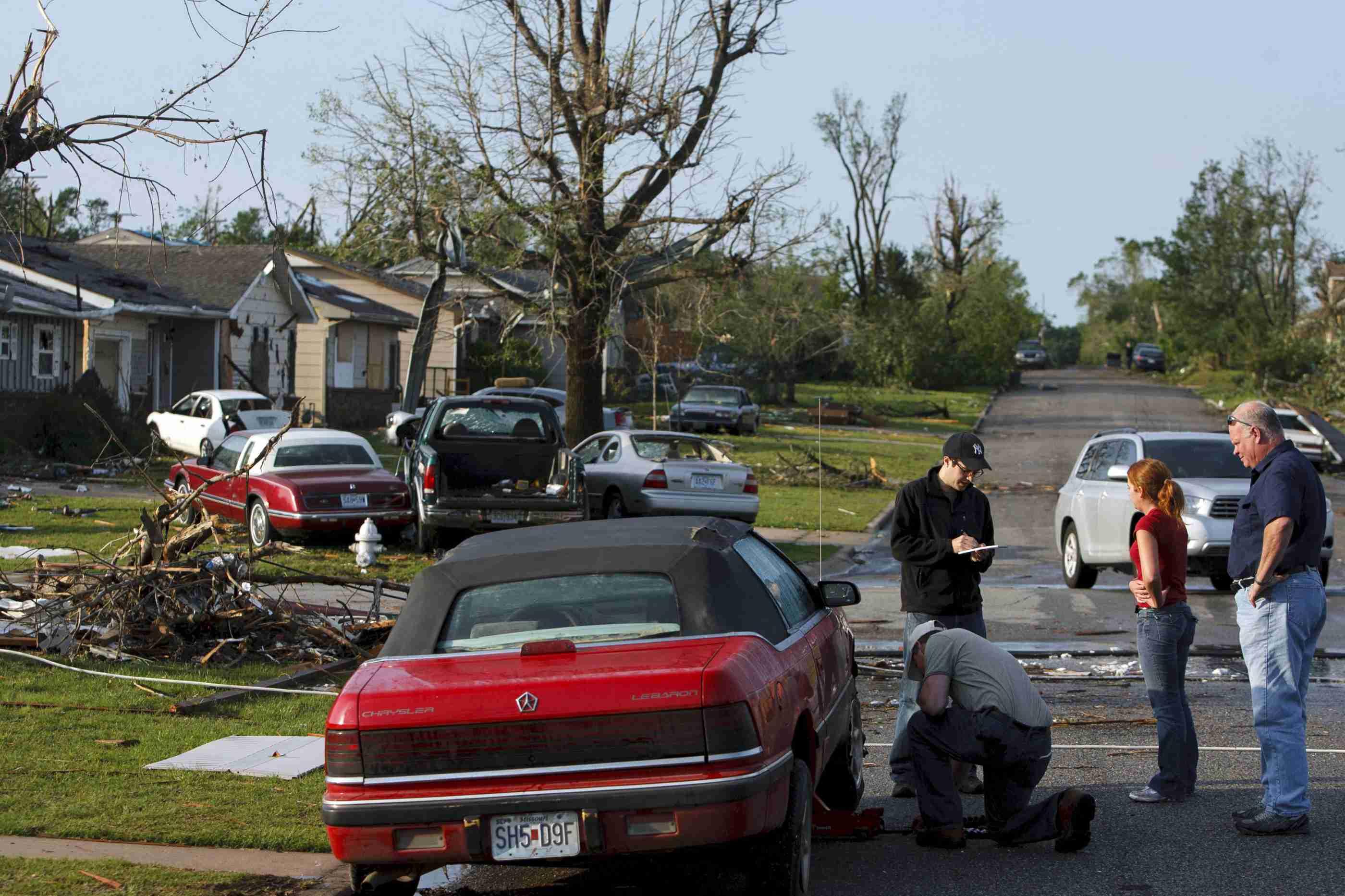 Local residents are pictured standing in the street in May 2011 following the destructive tornado in Joplin, Missouri.