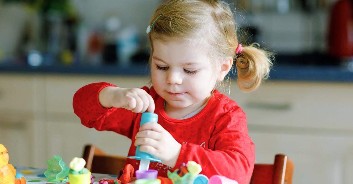 Toddler plays with crafting set