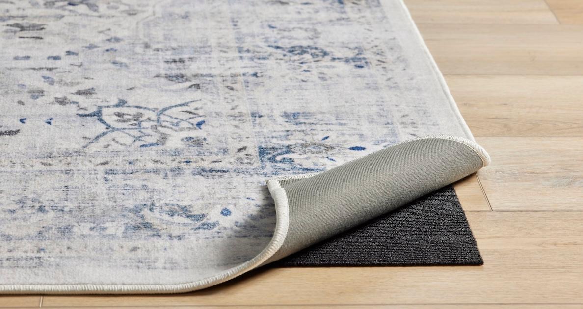 Rug with corner lifted on wood floor