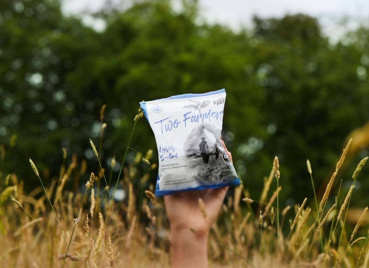 Bag of Two Farmers Crisps in a field