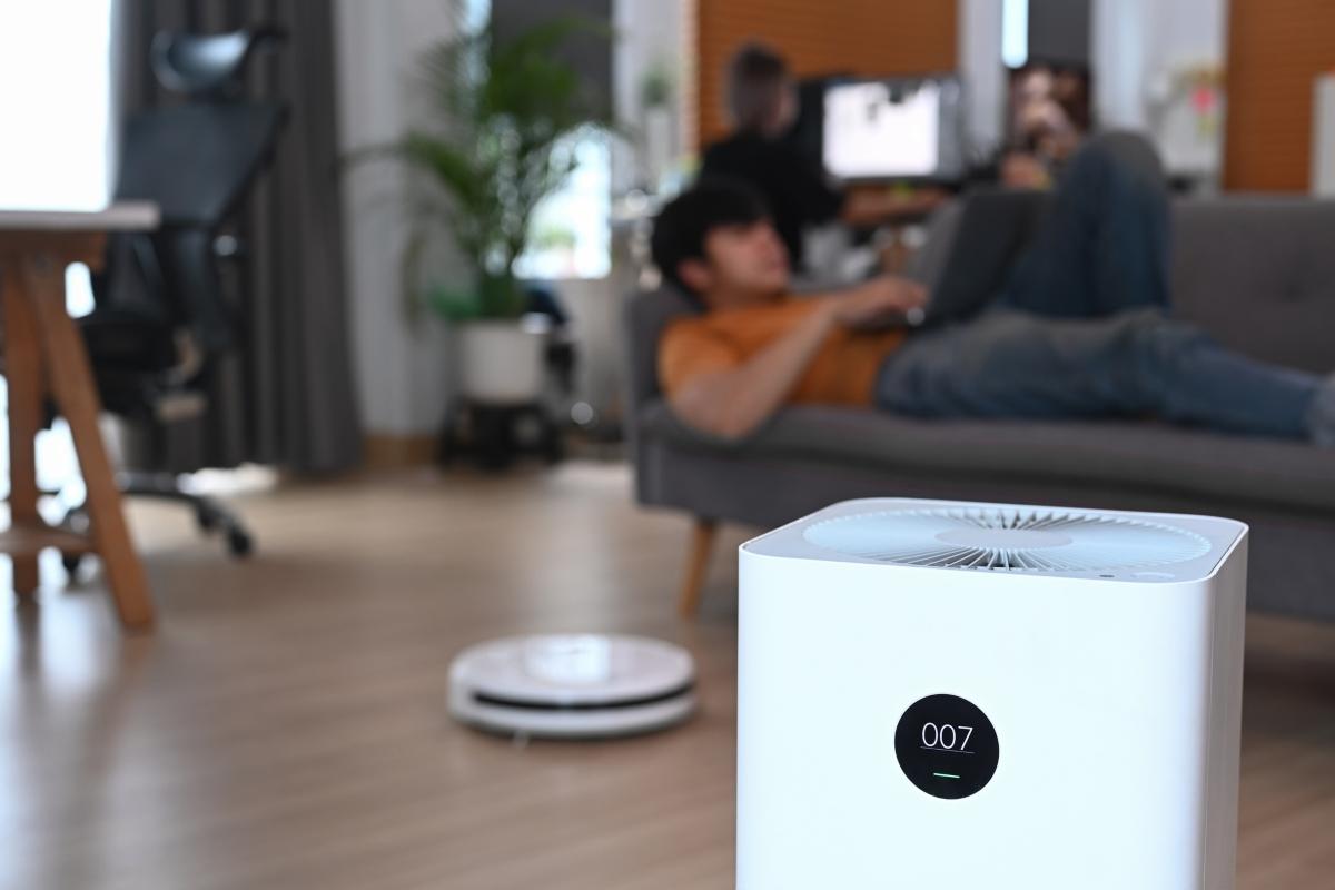 air purifier in a living room with man in background