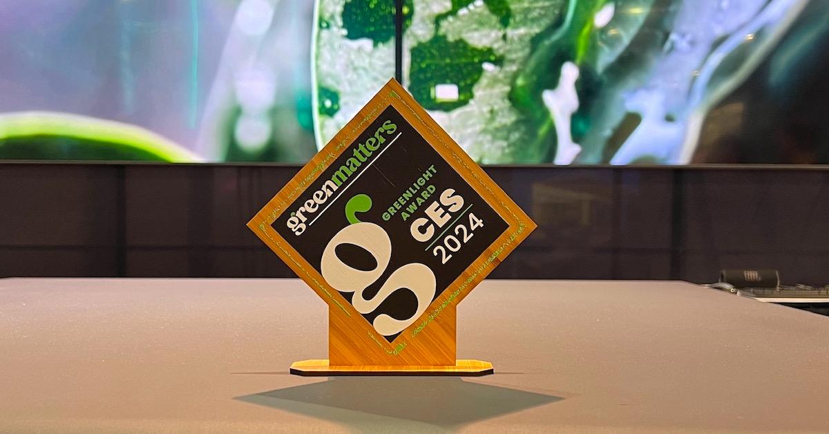 A Green Matters Greenlight Award, made of wood, sitting on a table.