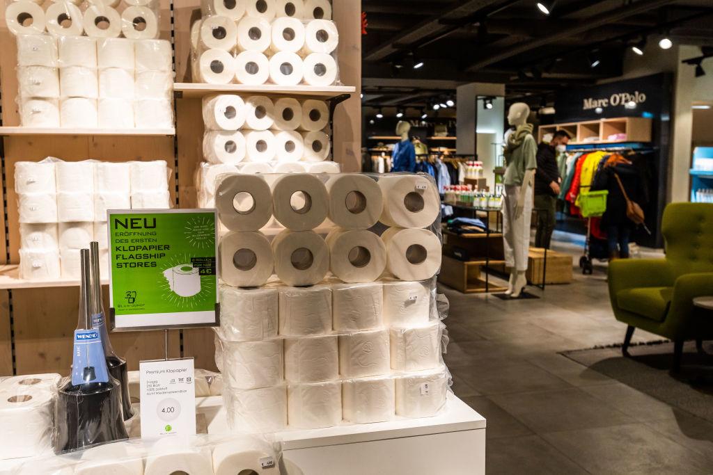 Toilet paper and fashion items are on display on the shelves and the sales floor at the Blum-Jundt fashion store. 