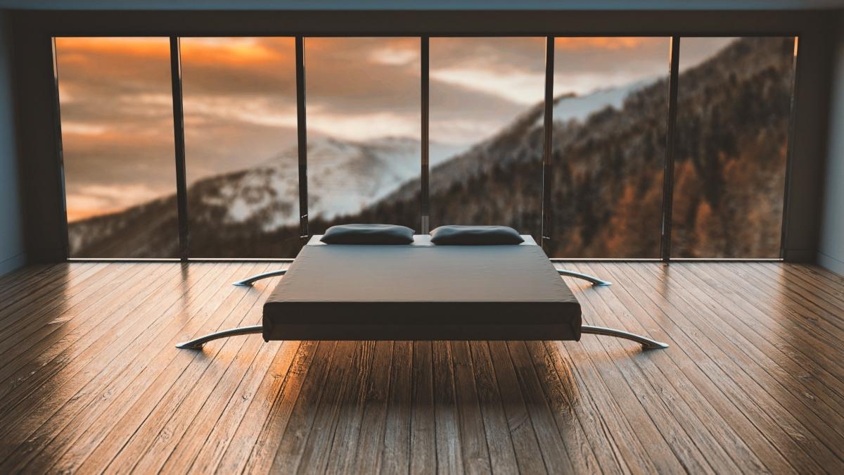 Bed in a room with a mountain view.