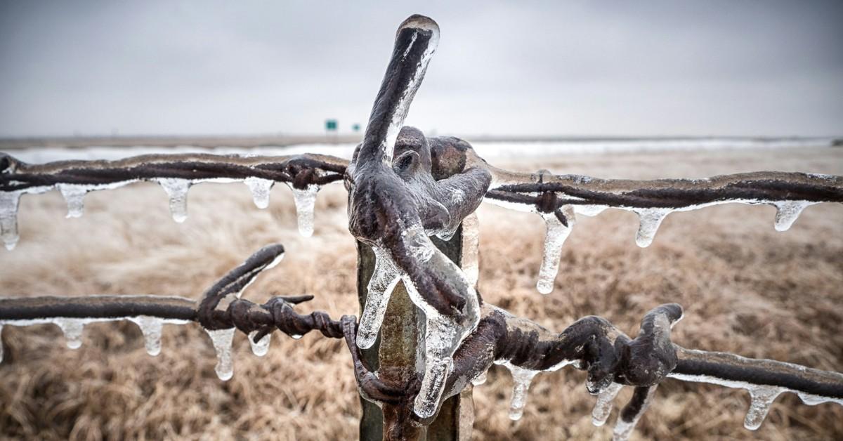 A fence post is frozen in ice