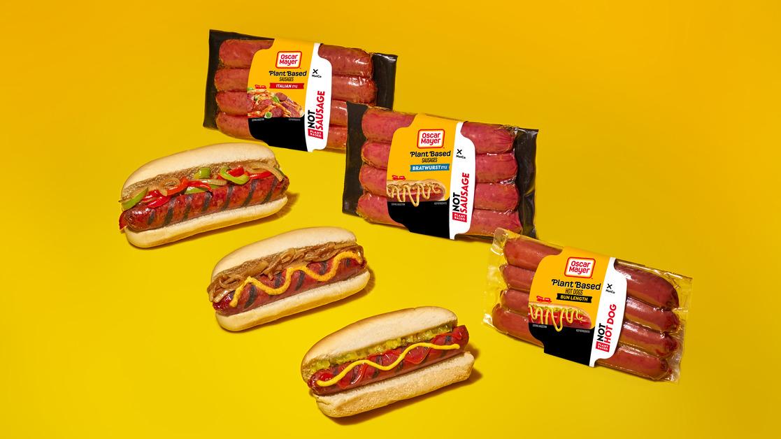 A promotional photo Oscar Mayer's plant-based sausages and hot dogs in wrappers next to the meat in buns. 