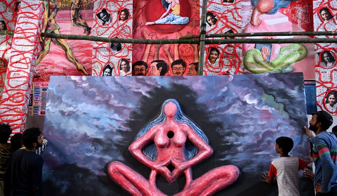 Art work displaying a woman with her hands clasped at her abdomen is pictured at a Pandal in Kolkata