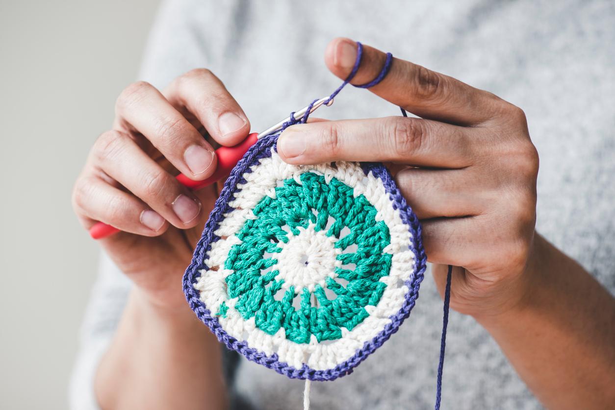 Close up of someone working on a crochet project.