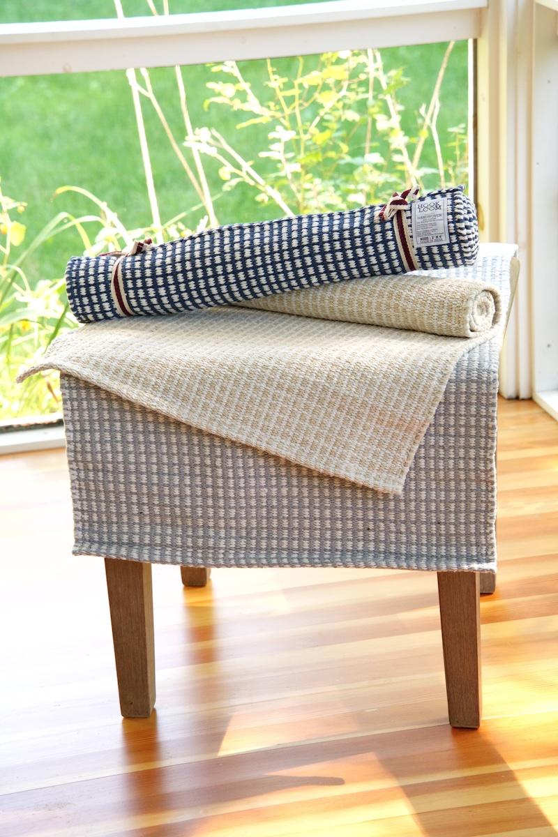 Pile of rugs on chair