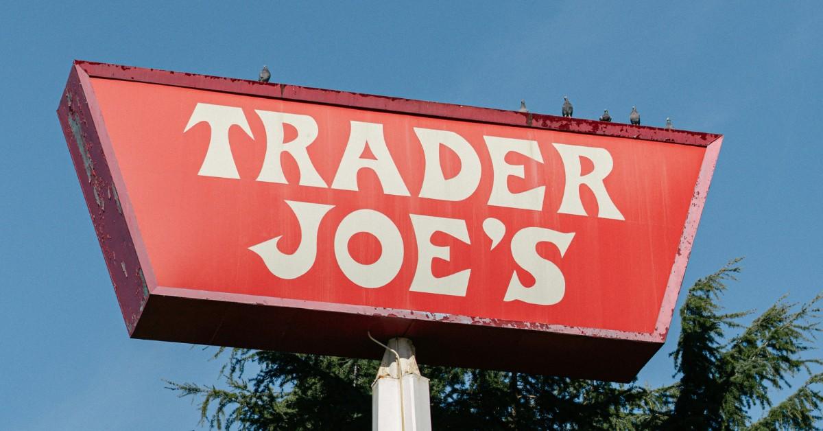 Birds sit on top of a Trader Joe's sign