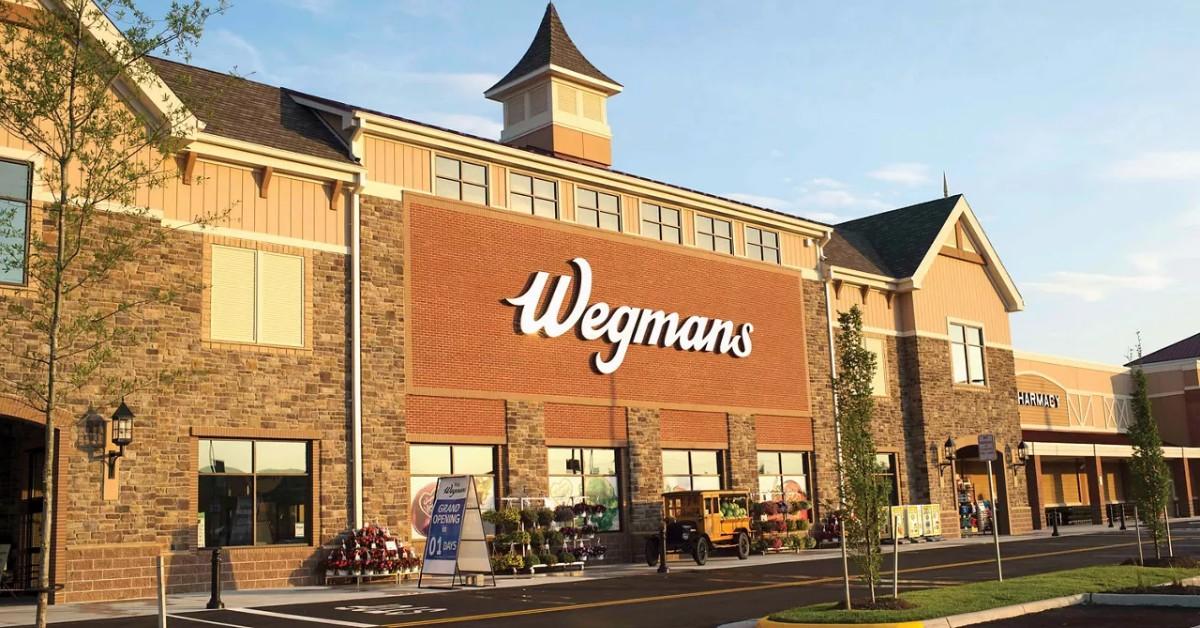 A Wegmans store with flowers and signs posted out front