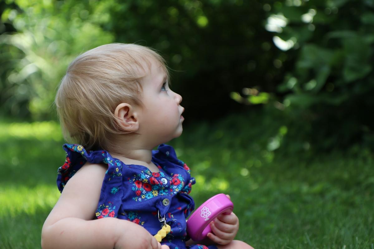 young child sitting in grass