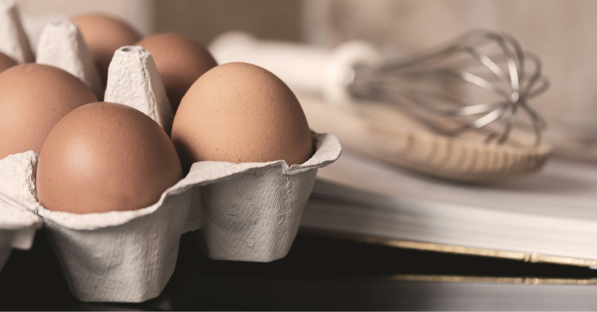 A closeup of brown eggs in a carton