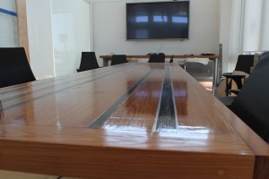 This board room table was made from wood reclaimed from the original structure on King Street. The dark wood is timbers that had been burned in a fire in the building many years ago.